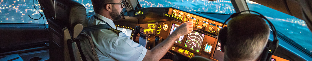 Image of a pilot in the cockpit of an aeroplane while in the air